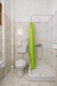 a bathroom with a toilet and a green towel at Ionian Breeze Apartments in Kavos