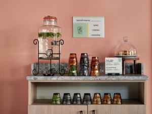 a display of glass bottles on a shelf at Hotel Boulevard in Stuttgart +30 photos