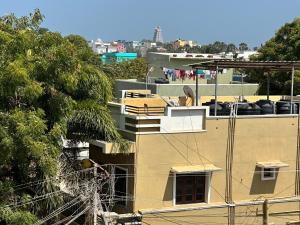 a yellow building with a balcony on top of it at Jacobs Cottage KG-F2 in Thiruchendur +5 photos