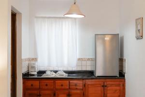 a kitchen with a sink and a refrigerator at Villa Baya in Bayahibe +83 photos