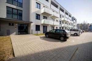 a car parked in a parking lot in front of a building at Apartament Staymonte in Wrocław