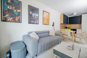 a living room with a blue couch and a table at Apartament Staymonte in Wrocław
