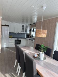 a kitchen with a wooden table and chairs at Ocean View Cottage in Alta