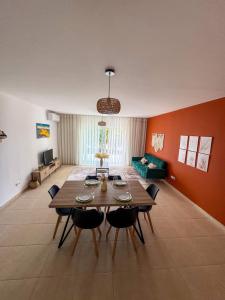 a living room with a wooden table and chairs at Apartamento Paradise beach in Prainha