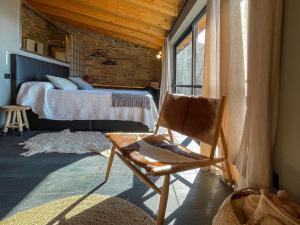a bedroom with a bed and a chair and a window at Cal Serni in Calbinyà +63 photos