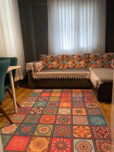 a living room with a couch and a rug at Small House in İzmir