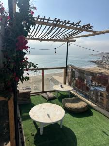 a patio with two tables and a view of the ocean at The Trizit in Taghazout
