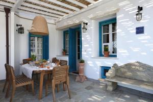 a dining room with a table and chairs at Tinos Grand Villa 6BR 15ppl Infinite Views in Triandáros