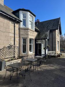 a group of tables and chairs outside of a building at Crannach House bed and breakfast and self catering apartments in Ballater