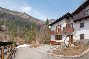 a house with a balcony on the side of it at Ciasa Civetta in Piaia