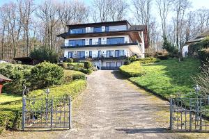 a large house on a hill with a driveway at Ferienwohnungen Petrisberg in Trier