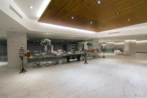 a large lobby with a counter in the middle at MS Milenium Monterrey Curio Collection by Hilton in Monterrey +133 photos