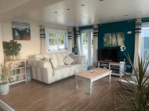 a living room with a couch and a coffee table at Dream view holiday home in Castletown