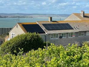 a house with solar panels on the roof at Dream view holiday home in Castletown
