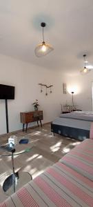 a bedroom with a bed and a table and a couch at Juliusruh Strandparadies 2 in Juliusruh