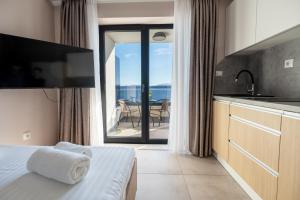a bedroom with a bed and a view of the ocean at Wind Rose Bura-beachfront in Igrane +57 photos