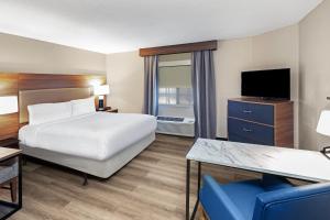 a hotel room with a bed and a television at Candlewood Suites - Topeka West by IHG in Topeka +50 photos