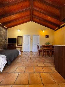 a bedroom with a bed and a table and chairs at Bordon wines, estate with accommodation in Dekani +23 photos