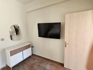 a room with a flat screen tv on the wall at Fiore Hill Sea View Studios in Vasilikos