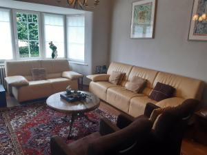 a living room with two couches and a table at Villa in Middelkerke near the Beach in Middelkerke
