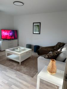 a living room with a couch and a tv at Happy house katajanokka in Helsinki