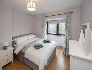 a bedroom with a large bed and a window at Sleepy Rock in Dungarvan