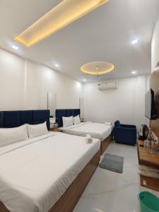 a room with two beds and a tv in it at Hotel Golden Palace in Agra +73 photos