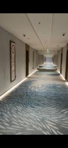 a long hallway with a blue and white carpet at فندق جولدن نيو سمارت لاكجري - Golden New Smart Hoteluxury in Abha