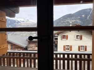 a view of a house from a window at Cosy duplex close to Verbier in Bruson