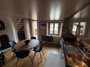 a kitchen with a table and chairs in a room at Cosy duplex close to Verbier in Bruson +9 photos