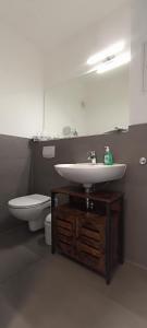 a bathroom with a sink and a toilet at Juliusruh Strandparadies 2 in Juliusruh +9 photos