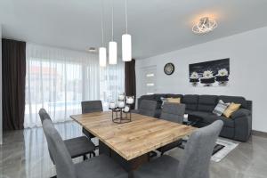 a dining room with a table and a couch at Mariva in Vir