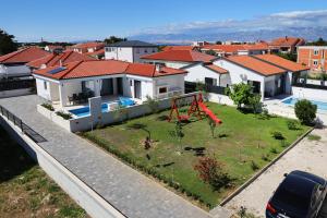 an aerial view of a house with a playground at Mariva in Vir