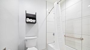 a white bathroom with a toilet and a shower at Oceanside, CA – Marina / Camp Pendleton in Oceanside +35 photos