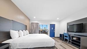 a hotel room with a bed and a flat screen tv at Oceanside, CA – Marina / Camp Pendleton in Oceanside