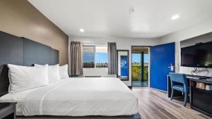 a hotel room with a large bed and a flat screen tv at Oceanside, CA – Marina / Camp Pendleton in Oceanside