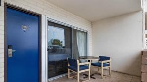 a patio with a table and two chairs and a blue door at Oceanside, CA – Marina / Camp Pendleton in Oceanside