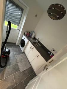 a kitchen with a sink and a counter top at Modern spacious Home in Rhyl in Rhyl