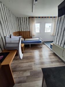 a living room with a couch and a table at Gästehaus Back - Reisfelder Hof in Reinsfeld