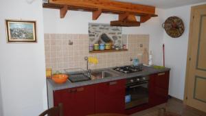 a kitchen with a sink and a stove at Le Petit Soleil in Saint-Christophe