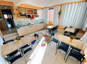 a restaurant with tables and chairs and a counter at Pousada Opção I in Triunfo