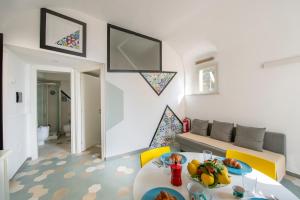a living room with a couch and a table at La mia casetta al mare in Minori +11 photos