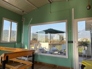 a green room with a patio with an umbrella at Golden Heights in Dehradun +37 photos