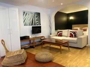 a living room with a couch and a table at Apartamentos Ondoloin in Vitoria-Gasteiz