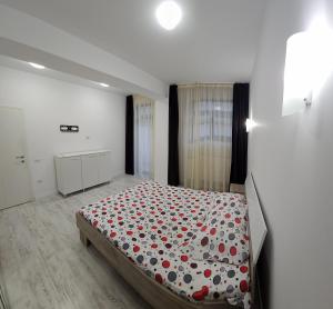 a bedroom with a bed with red hearts on it at Garsonieră O&M in Craiova