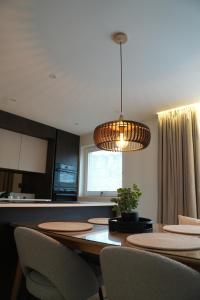 a kitchen with a table with chairs and a light fixture at 1st Floor Luxury 2-Bed Apt Sleeps 6 in St. Andrews