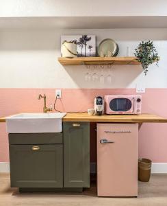a kitchen with a sink and a microwave at Abode Beach House in Clearwater Beach