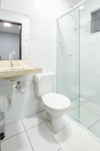 a bathroom with a toilet and a sink and a shower at Pousada Recanto do Sol BF in Baía Formosa