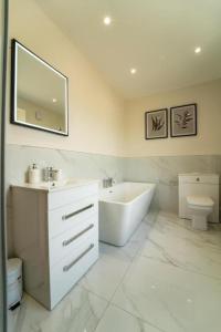 a bathroom with a sink and a tub and a toilet at Foundry Farm House - 4 bedrooms in Hexham