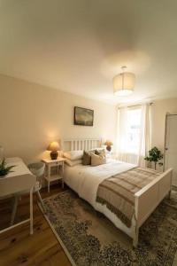 a bedroom with a white bed and a window at Foundry Farm House - 4 bedrooms in Hexham